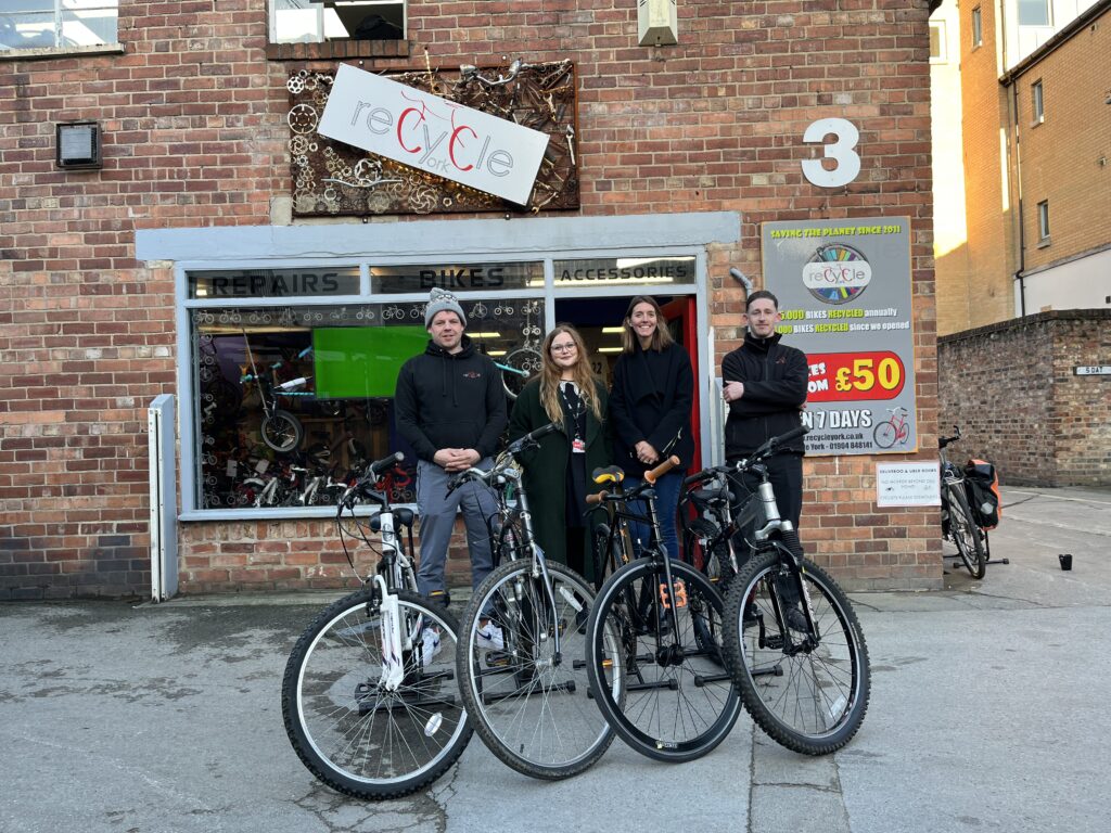 Young people in York outside Recycle York with bikes provided through the York Mix Toy Appeal